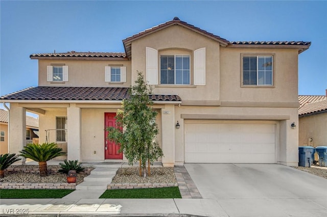 view of front of house featuring a garage, concrete driveway, and stucco siding