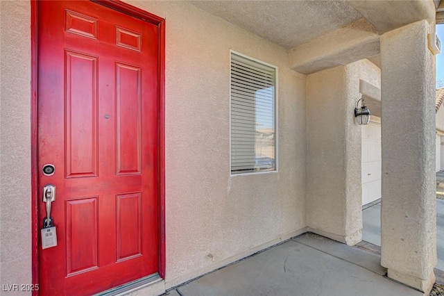 doorway to property with stucco siding