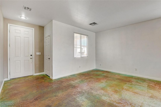 unfurnished room featuring visible vents and baseboards