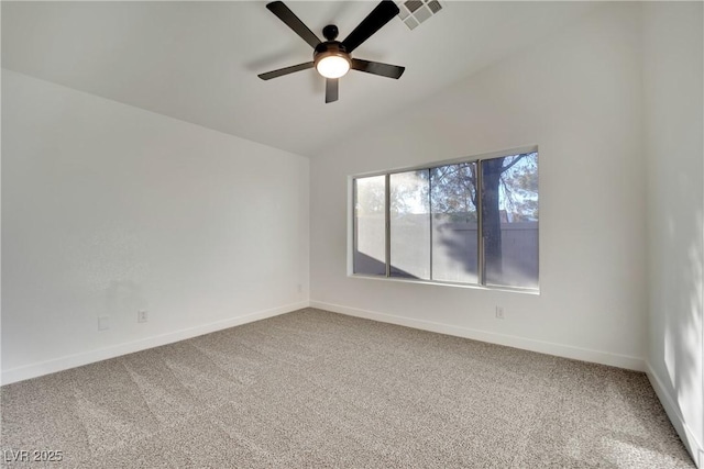 carpeted empty room with lofted ceiling, baseboards, visible vents, and a ceiling fan