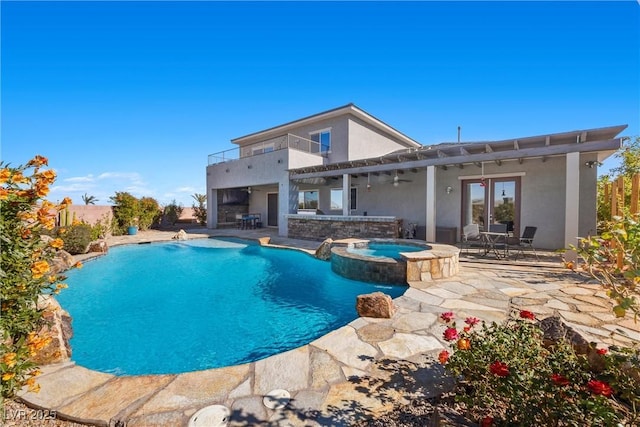 view of swimming pool with a pool with connected hot tub and a patio