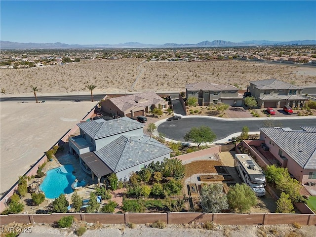 drone / aerial view featuring a residential view, a desert view, and a mountain view