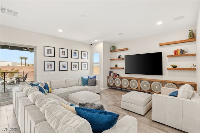 living room featuring recessed lighting, visible vents, and baseboards