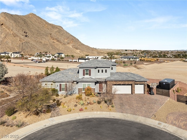 view of front facade with a garage, driveway, and a mountain view