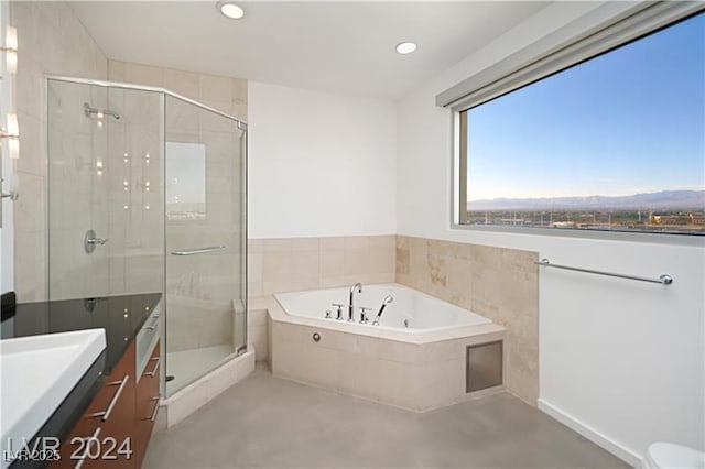 full bathroom with a stall shower, a garden tub, vanity, a mountain view, and recessed lighting