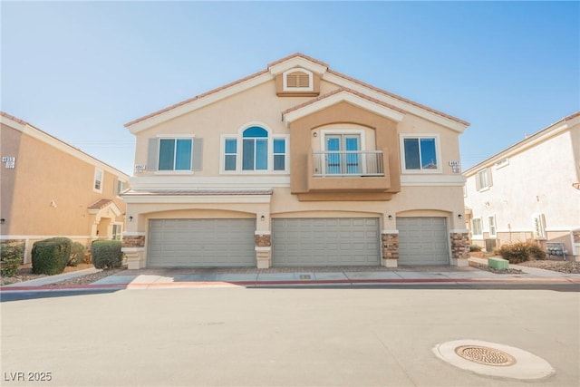 view of front of home with a garage and stucco siding