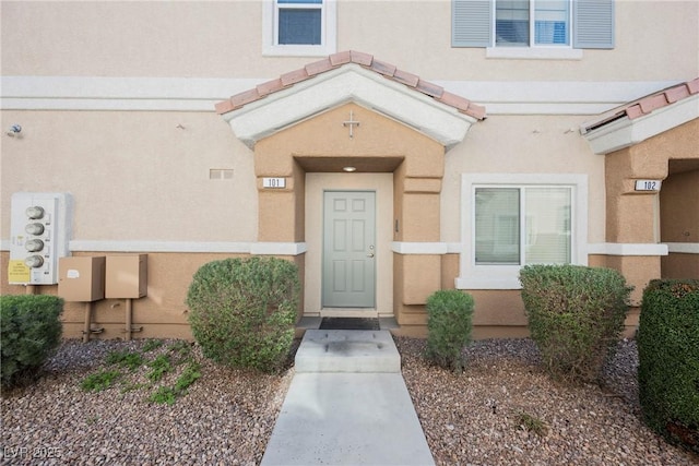 property entrance featuring stucco siding