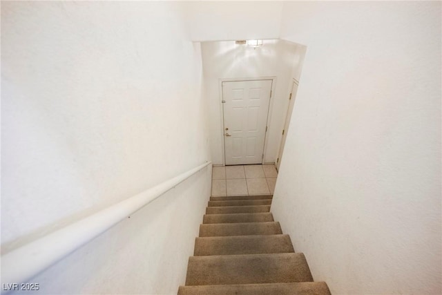 stairs featuring tile patterned flooring