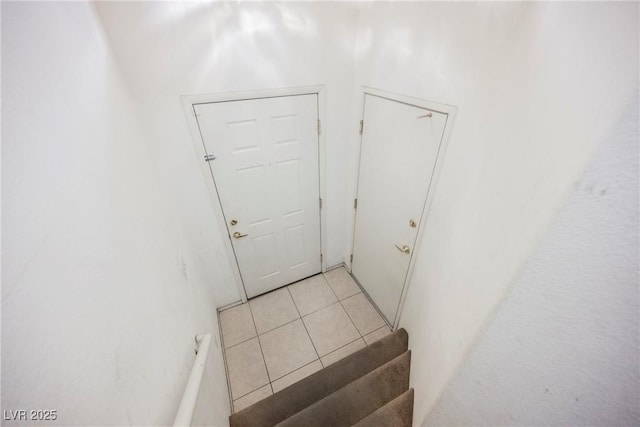 entryway with light tile patterned flooring