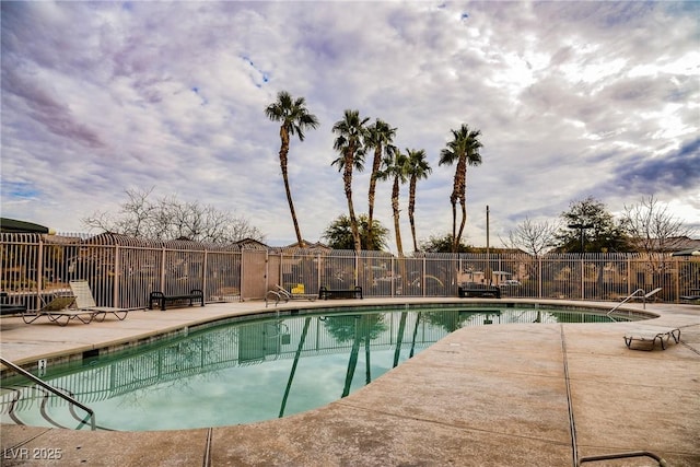 community pool featuring fence and a patio