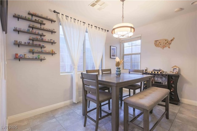 dining room with visible vents, baseboards, and light tile patterned floors