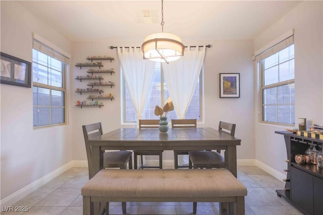 dining area featuring baseboards and light tile patterned floors