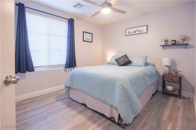 bedroom with visible vents, ceiling fan, baseboards, and wood finished floors