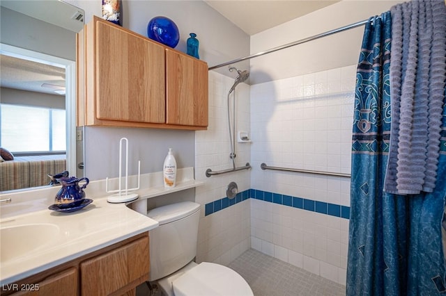 bathroom with toilet, a stall shower, and vanity