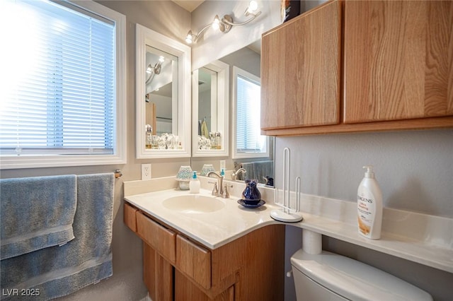 half bathroom featuring toilet and vanity