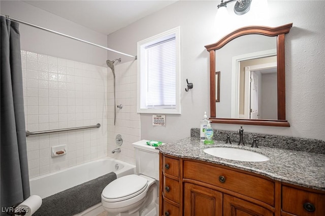 bathroom with shower / bath combo with shower curtain, vanity, and toilet