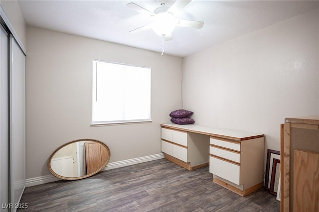 interior space with ceiling fan, dark wood-style flooring, a closet, and baseboards