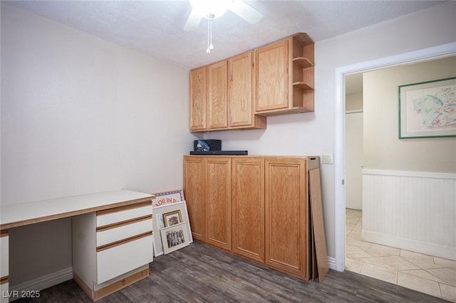 kitchen with dark wood-style flooring, open shelves, built in desk, and light countertops