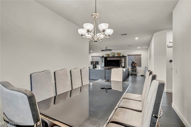 dining area with recessed lighting, ceiling fan with notable chandelier, visible vents, baseboards, and dark wood-style floors