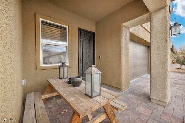 view of exterior entry with stucco siding