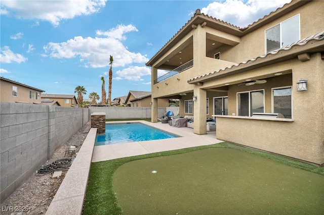 view of swimming pool with ceiling fan, a patio area, a fenced backyard, and a fenced in pool