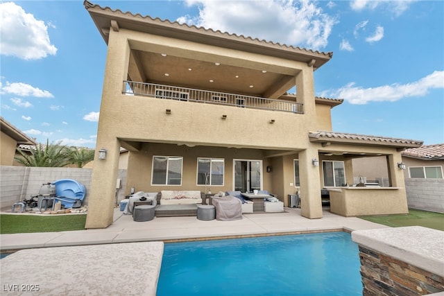 rear view of house featuring a patio, a balcony, area for grilling, a fenced backyard, and an outdoor living space