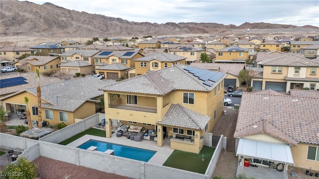 exterior space with a residential view, a fenced backyard, and a mountain view