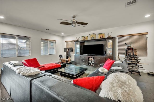 living room with ceiling fan, recessed lighting, wood finished floors, visible vents, and baseboards