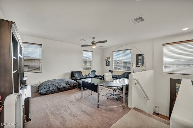 bedroom featuring light carpet, visible vents, and a ceiling fan