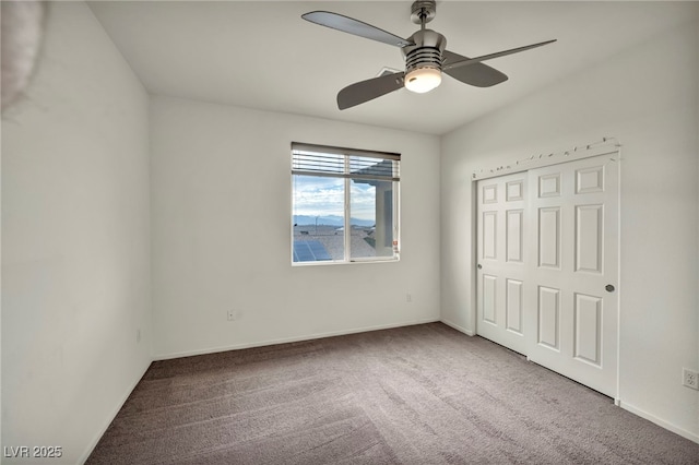 unfurnished bedroom featuring a ceiling fan, a closet, carpet flooring, and baseboards