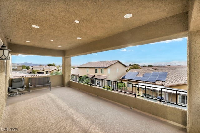 view of patio featuring a balcony and a residential view