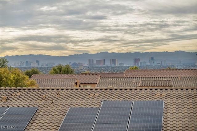 exterior space featuring a mountain view and a city view