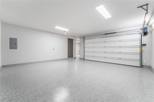 garage featuring electric panel and baseboards