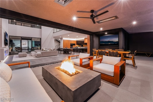 home theater with a ceiling fan, visible vents, a textured ceiling, and recessed lighting