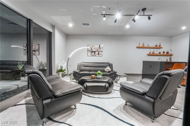 living room featuring visible vents, indoor wet bar, and recessed lighting