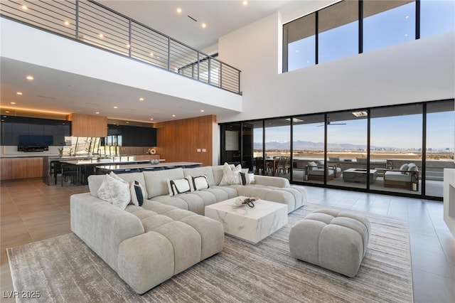 living area featuring recessed lighting and light tile patterned floors