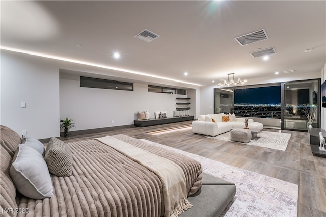 bedroom with wood finished floors, visible vents, and recessed lighting