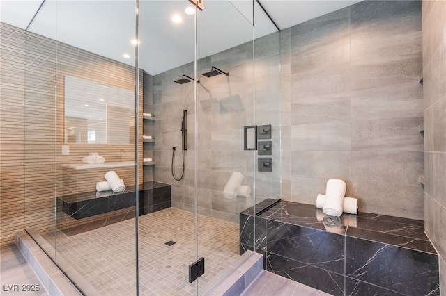 bathroom featuring a stall shower and tile walls