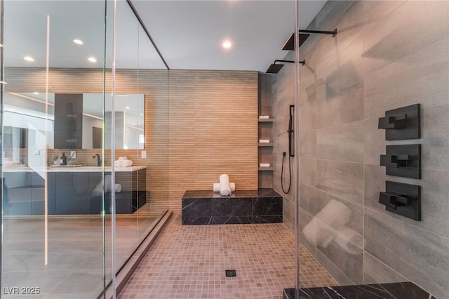 full bathroom featuring tile walls, a shower stall, vanity, and recessed lighting