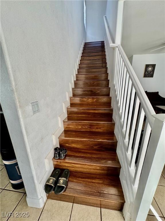 stairs featuring tile patterned flooring