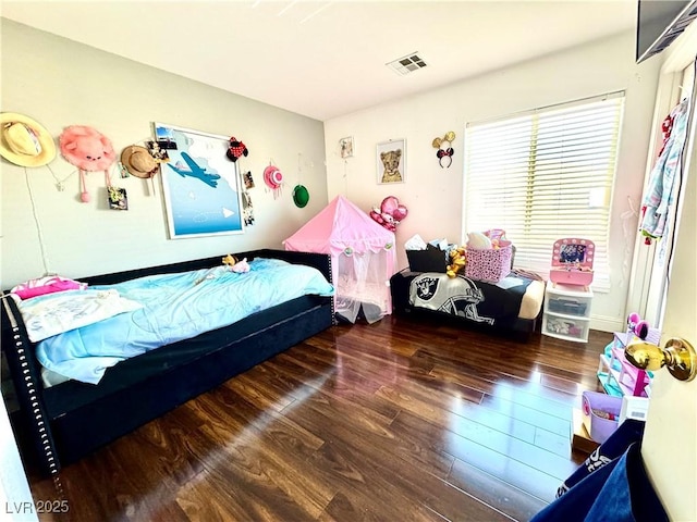 bedroom featuring dark wood-type flooring and visible vents