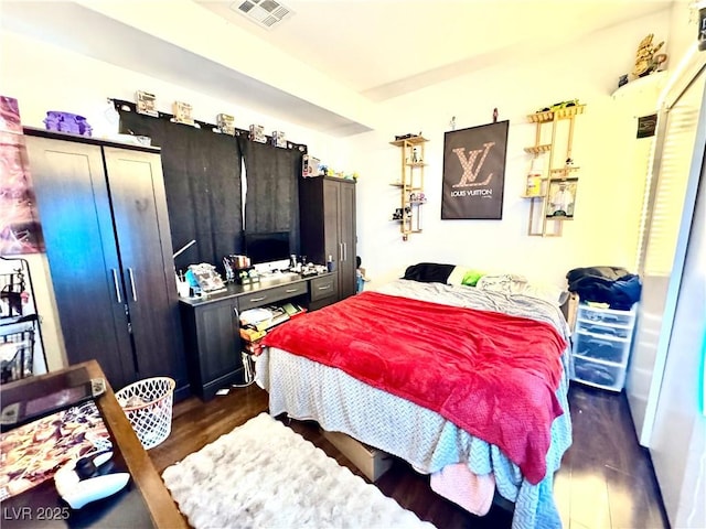 bedroom featuring dark wood finished floors and visible vents