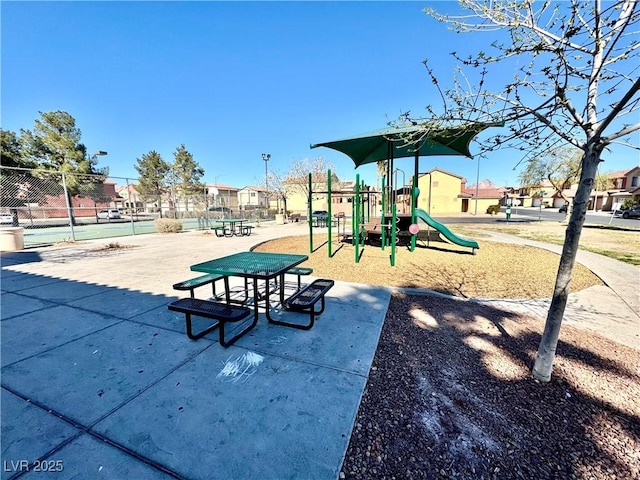 community play area with fence and a residential view