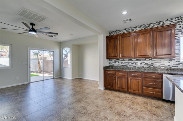 kitchen featuring tasteful backsplash, visible vents, open floor plan, and dishwasher