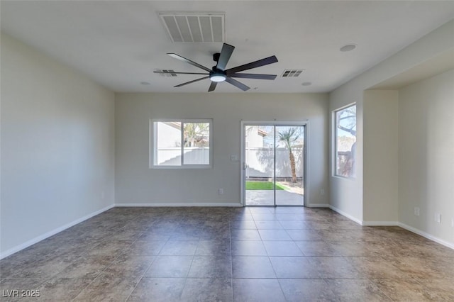 spare room with a ceiling fan, visible vents, and baseboards