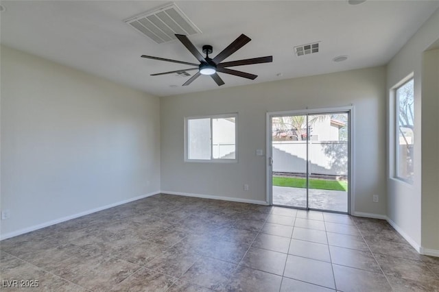 spare room with visible vents, ceiling fan, and baseboards