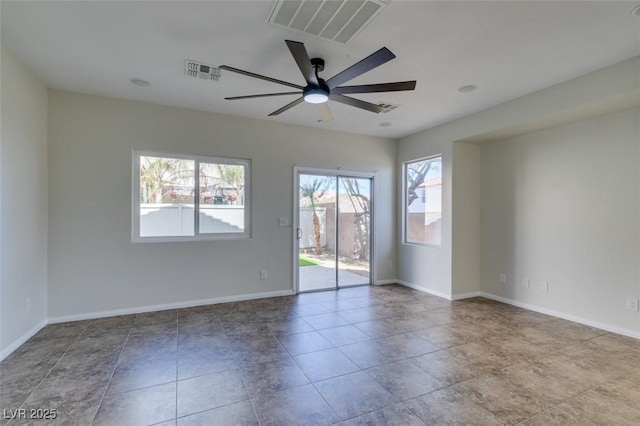 unfurnished room featuring baseboards, visible vents, and a ceiling fan