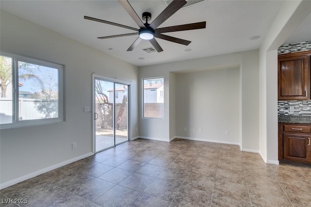 interior space with visible vents, ceiling fan, and baseboards