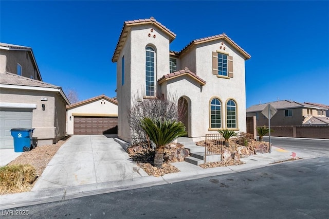 mediterranean / spanish house with driveway, a residential view, a tiled roof, and stucco siding