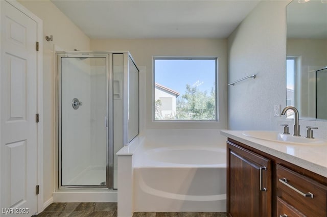 full bath with a garden tub, a shower stall, and vanity